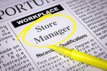 Obraz premium Store Manager - Newspaper sheet with ads and job search, circled with yellow marker, Blurred image and selective focus