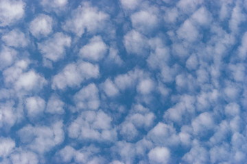 small white cumulus clouds in blue sky
