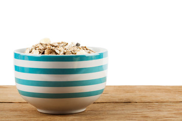 Muesli in bowl and fresh fruits