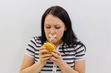 Portrait of a Women close his mouth with hand refusing food