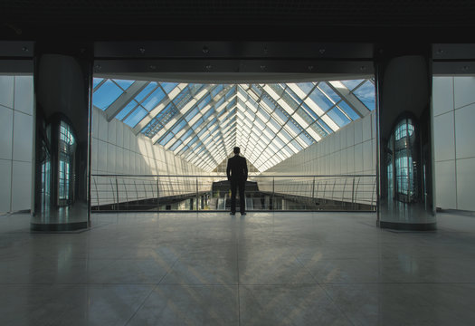 The man stand on office hall near the column