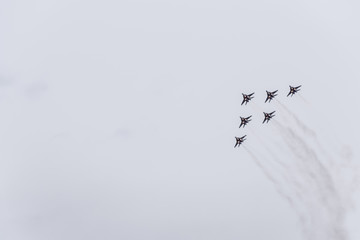 Air show in the sky above the Krasnodar airport flight school. Airshow in honor of Defender of the Fatherland. MiG-29 in the sky.