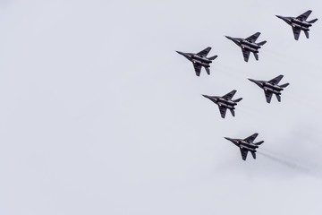 Air show in the sky above the Krasnodar airport flight school. Airshow in honor of Defender of the Fatherland. MiG-29 in the sky.