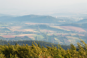 Numerous hills in mist at sunset