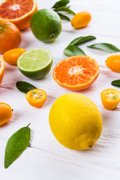 Fresh citrus fruits with leaves. Orange, lemon, mandarin, lime, kumquat