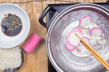Chef boiling kamaboko (fish cake) in pot
