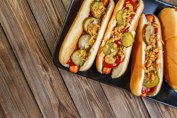 American hot dog with pickles,onions, ketchup and mustard