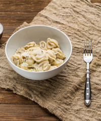 Meat dumplings - russian pelmeni, ravioli with meat on a white plate
