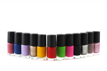 Colorful nail polish bottles on background