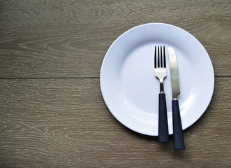 Empty white plate on a wooden background