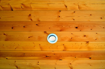 Recessed light in pine ceiling