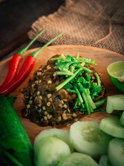 Vintage style Thai traditional food Nam Prik Num (Northern Thai Green Chilli Dip) on top and wooden background wallpaper