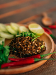 Vintage style Thai traditional food Nam Prik Num (Northern Thai Green Chilli Dip) on top and wooden background wallpaper