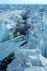 Ice hummocks on the northern shore of Olkhon Island on Lake Baikal. Fresh crack broke the thick ice. Fresh clean water rises from the depths and freeze in the cold. Ice Storm. Photo partially tinted