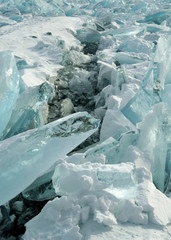 Ice hummocks on the northern shore of Olkhon Island on Lake Baikal. Fresh crack broke the thick ice. Fresh clean water rises from the depths and freeze in the cold. Ice Storm. Photo partially tinted