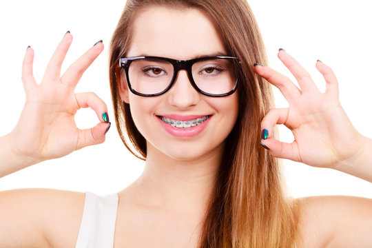 Happy nerdy teenage with brace wearing eyeglasses