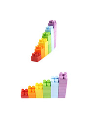 Naklejka premium Growing stacks of toy bricks isolated