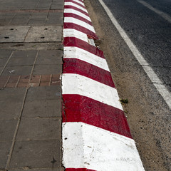 Red and white concrete road curb