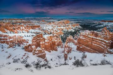 Hoodoos Covered in Winter Snow During Sunset in Bryce Canyon National Park, Utah