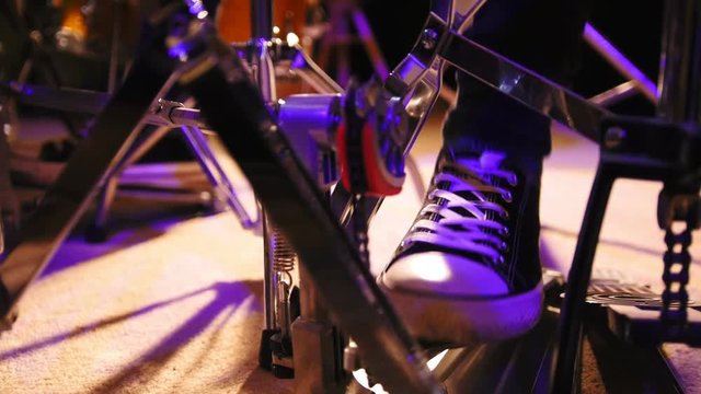 Drummer's foot in sneakers moving drum bass peda