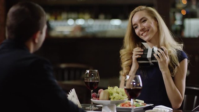 smiling cute lady getting a present to valentines day