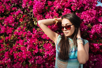 Woman posing near the flower bush