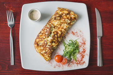 Fresh breakfast - omelette with cherry tomato and greens