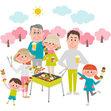 family enjoying barbecue outdoors