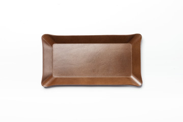 A brown leather pencil tray isolated white.