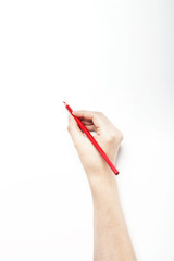A woman hand hold a red color pencils isolated white.
