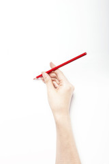 A woman hand hold a red color pencils isolated white.