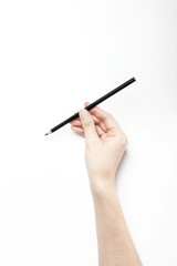 A woman hand hold a black pencils isolated white.