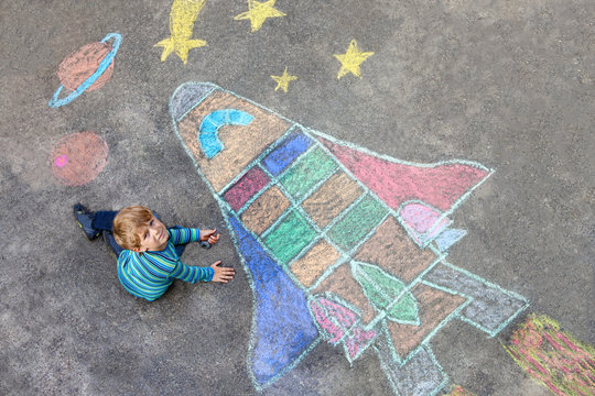 little kid boy flying by a space shuttle chalks picture