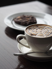Cup of cuppuccino with cookie