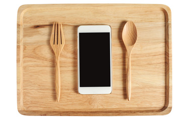wooden plate with spoon fork and cell phone