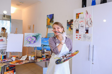 Women beautiful painter posing and smiling, laughing into camera