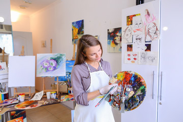 Women beautiful painter posing and smiling, laughing into camera