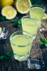 Italian traditional liqueur limoncello with lemon