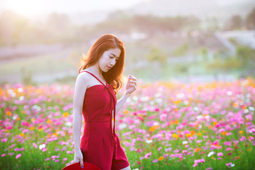 Young beautiful woman with a Cosmos flower.