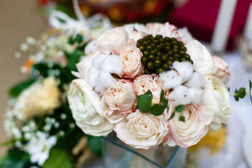 Beautiful winter wedding bouquet with cones, cotton and spruce branches. Bride holding a bridal bouquet.
