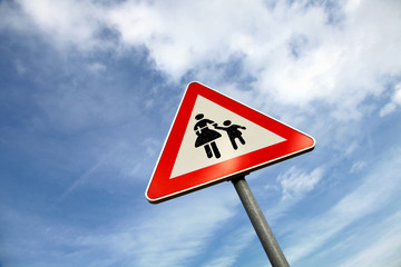 Metal traffic triangle road sign with pedestrian mark background.