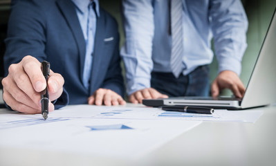 Team work process. young business managers crew working with new startup project. labtop on wood table, typing keyboard, texting message, analyze graph plans