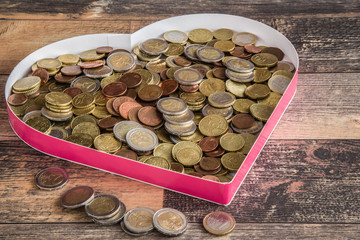 Love money. Coins in the heart shape. Euro coin stocks from different countries.