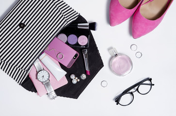 Top view striped clutch woman accessories and pink shoes .