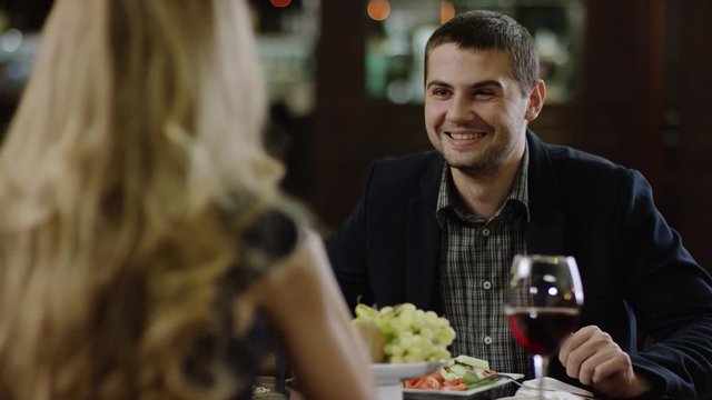 back view of a blondie talking to boyfriend in romantic atmosphere