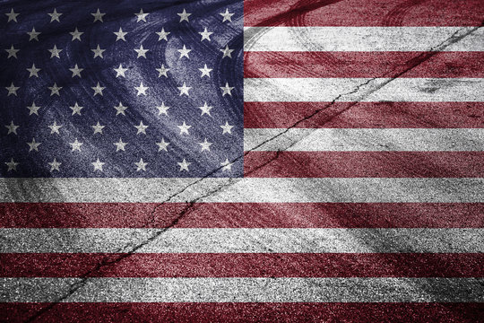 United States of America flag painted on the asphalt road with crossing of tires tracks. Conceptual motorsport competition background.