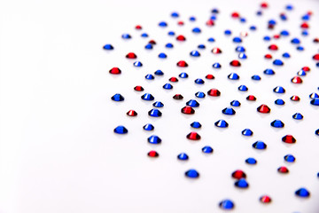 Rhinestones blue and red on a white background acrylic.