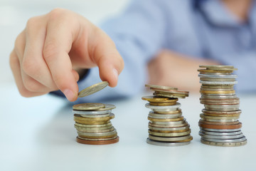 The concept of children's economic education. Young boy build a tower by coins.