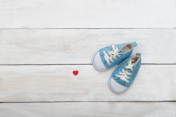 Blue shoes for a little boy on a wooden background. flat lay