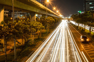 Fototapeta na wymiar The light of car on the road with traffic jam at night in Bangkok Thailand.